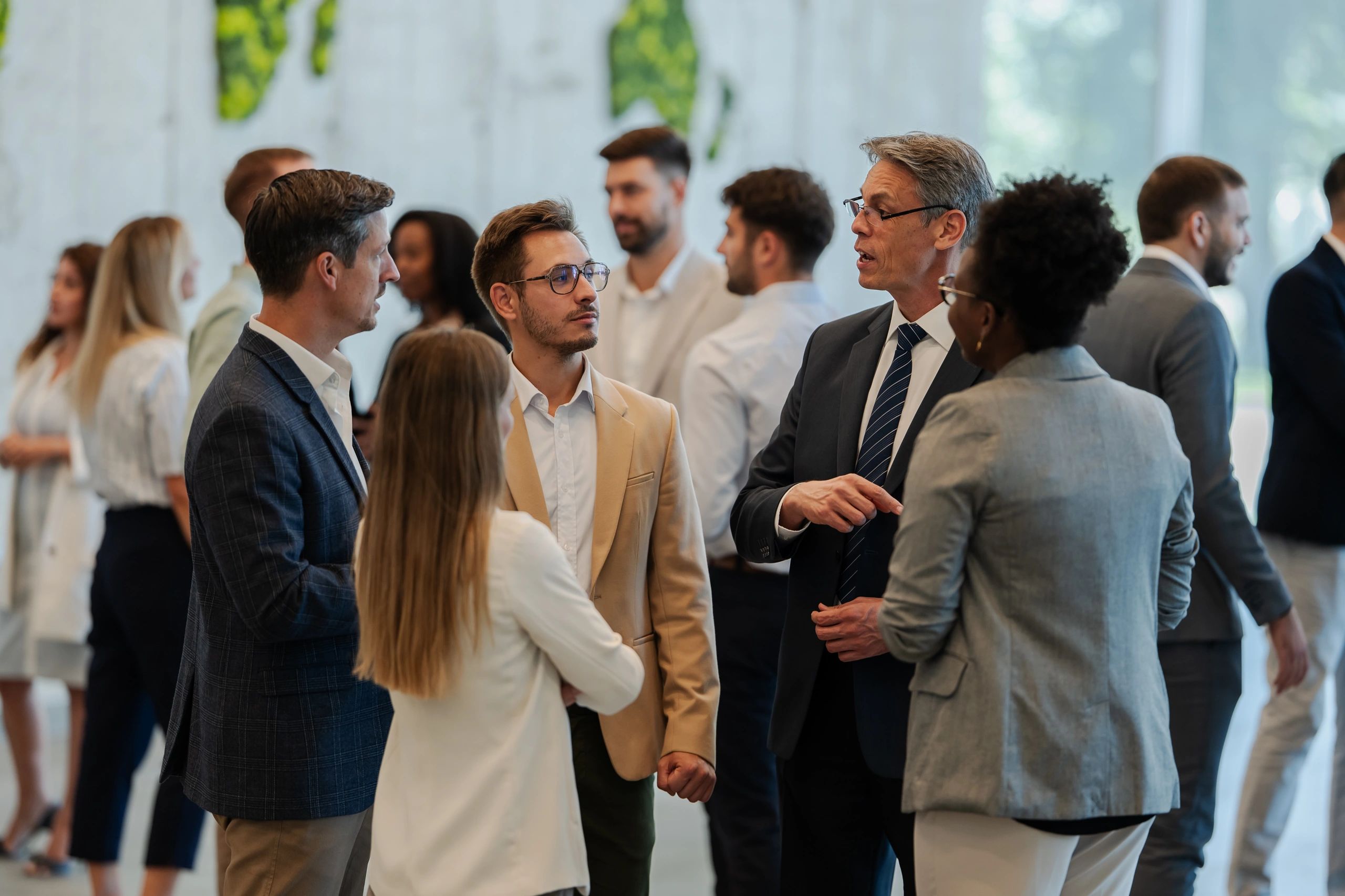 Professionals networking and discussing ideas at a business event
